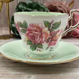 Paragon imperfect mint green and cabbage roses double warrant tea cup and saucer set. Vintage bone china England