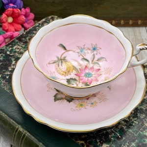 Paragon pale pink with pink and yellow flower and leaf double warrant tea cup and saucer set. Vintage bone china England