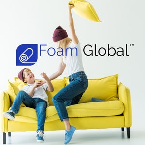 May include: A woman in a white shirt and jeans playfully throws a pillow at a boy sitting on a yellow sofa. The boy is wearing a white shirt, blue jeans, and a red beanie. The text "Foam Global" is visible in the background.