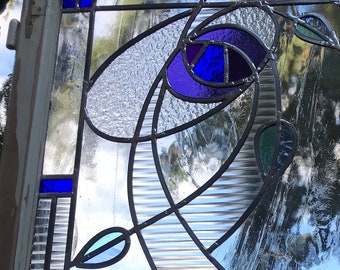 Stained glass panel in old window frame