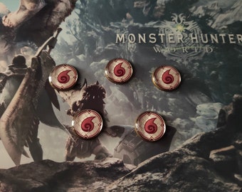May include: Five gold-colored pins with a red and white swirl design. The pins are arranged in a semi-circle on a background with the text "Monster Hunter World".