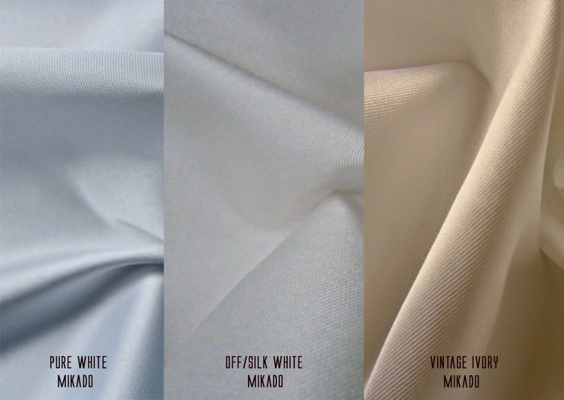 K&ouml;nnte beinhalten: Drei Stoffmuster in verschiedenen Wei&szlig;t&ouml;nen: Reinwei&szlig;, Off-White und Vintage Ivory. Jedes Muster ist mit der Farbe und dem Stofftyp Mikado beschriftet.