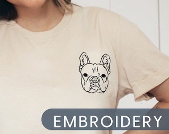 May include: A white t-shirt with a black embroidered image of a French Bulldog on the left chest. The text "EMBROIDERY" is printed in gray below the image.