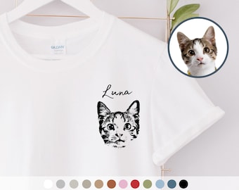 May include: White t-shirt with a black and white illustration of a cat's face and the name "Luna" printed on the front.