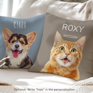 Puede incluir: Dos cojines decorativos con retratos de mascotas. Un coj&iacute;n presenta un perro Corgi con el nombre "Kiara" encima. El otro coj&iacute;n tiene un gato atigrado naranja con el nombre "Roxy" y un halo. Ambos cojines est&aacute;n sobre un sof&aacute; de color claro.
