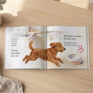 May include: An open book with a watercolor illustration of a golden-brown dog leaping towards a bowl labeled "Teddy." Text includes "I wag my tail and stretch up tall" and "My bowl is empty - oh dear me!"