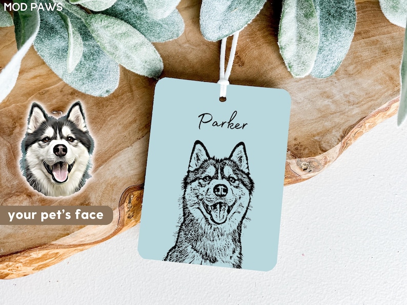 May include: A light blue car air freshener with a black and white illustration of a Husky dog. The dog's name, "Parker", is written in black cursive above the illustration.