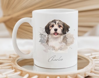May include: A white ceramic mug featuring a detailed illustration of a brown and white Havanese puppy with a watercolor-style background. Below the puppy, the name Charlie is printed in a black cursive script font on the front of the mug.