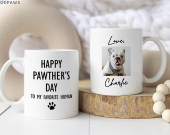 May include: Two white ceramic mugs. One mug features the black text "HAPPY PAWTHER'S DAY TO MY FAVORITE HUMAN" with a paw print icon. The other mug displays a photograph of a French Bulldog with the black text "Love, Charlie" above and below it.