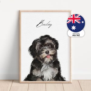 May include: A framed watercolour print of a black and white dog with its tongue out. The dog's name, "Bailey," is written above the image in cursive. The print is in a light wood frame.
