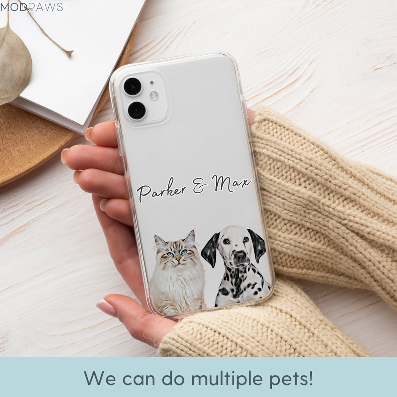 May include: A clear phone case with a white background and a black and white illustration of a cat and a dog. The text "Parker & Max" is printed on the case.