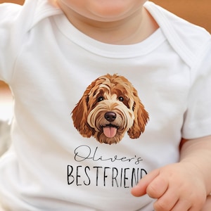 May include: White baby onesie featuring a brown and white dog illustration and the text "Oliver's Best Friend".
