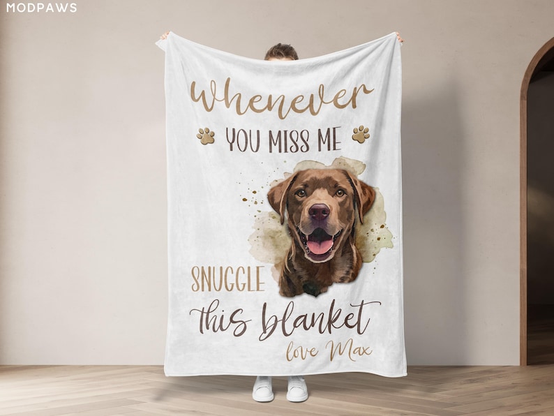 May include: White blanket with a watercolor image of a brown Labrador Retriever. The blanket has text that reads "Whenever you miss me, snuggle this blanket, love Max."
