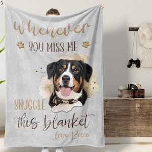 May include: A light gray blanket with a watercolor image of a dog. The blanket has the text "Whenever you miss me, snuggle this blanket, love Rocco" in brown script. The dog is black, brown, and white.