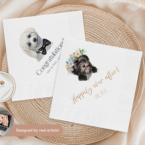 May include: White paper napkins with watercolor illustrations of dogs. One napkin says "Congratulations" with a dog wearing a bow tie. The other says "Happily ever after!" with a dog wearing a floral crown.