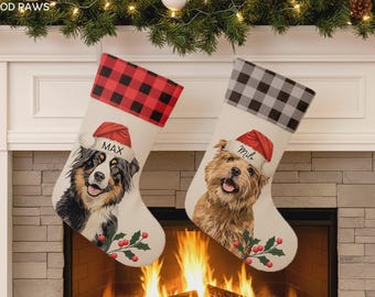 May include: Two off-white Christmas stockings featuring illustrations of dogs wearing Santa hats. The left stocking has a red and black buffalo plaid cuff and the name MAX. The right stocking has a gray and black buffalo plaid cuff and the name Milo.