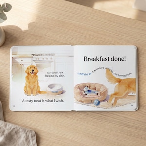May include: A children's book open to two pages. One page shows a golden retriever sitting near a dog bowl labeled "Buddy" with the text "I sit and wait beside my dish." The other page shows a dog bed and the text "Breakfast done!"
