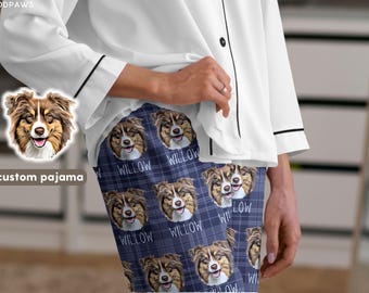 May include: A white button-down pajama top with black piping paired with navy blue plaid pajama bottoms featuring a repeating pattern of a brown and white dog face and the text WILLOW printed in white lettering across the fabric.