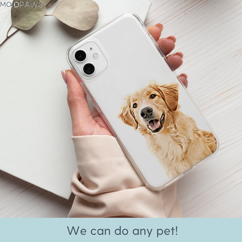 May include: A clear phone case with a printed image of a golden retriever dog. The dog is looking at the camera and has a happy expression. The case is designed to fit a smartphone.