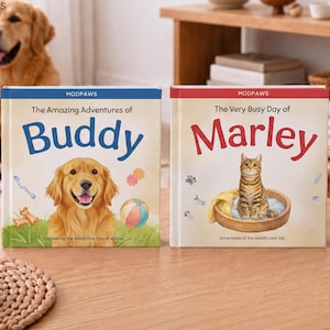 May include: Two hardcover books titled The Amazing Adventures of Buddy and The Very Busy Day of Marley. The first book features a golden retriever illustration, while the second shows a tabby cat in a bed. Both books include the brand name MODPAWS.