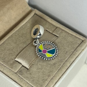 May include: Silver charm with a colorful wheel design and the text "Cape May NJ".