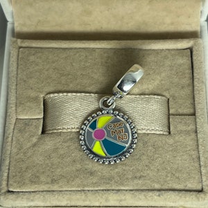 May include: Silver charm with a colorful beach ball design and the text "Cape May NJ".
