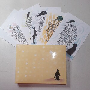 May include: A set of six cards with inspirational messages and animal illustrations. The cards are printed on white paper with a light blue background and feature a variety of animals, including a bee, a rabbit, a mouse, and a snail. The cards are packaged in a yellow box with white stars.