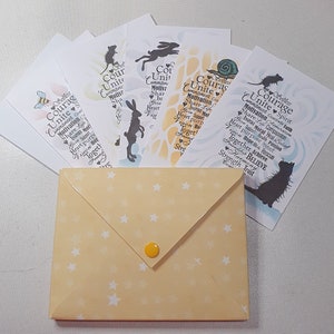 May include: A set of six cards with a yellow envelope. Each card features a different animal silhouette and the word "Courage" with a list of words related to courage, such as "unite", "motivation", "inspire", and "believe".