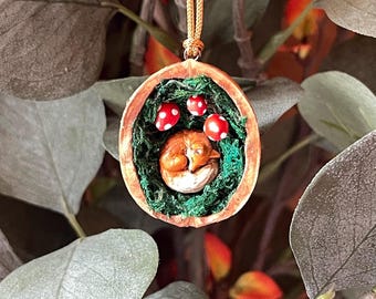 Walnut shell with hand painted cute sleeping fox on a bed of moss with toadstools. Unique handmade decoration.