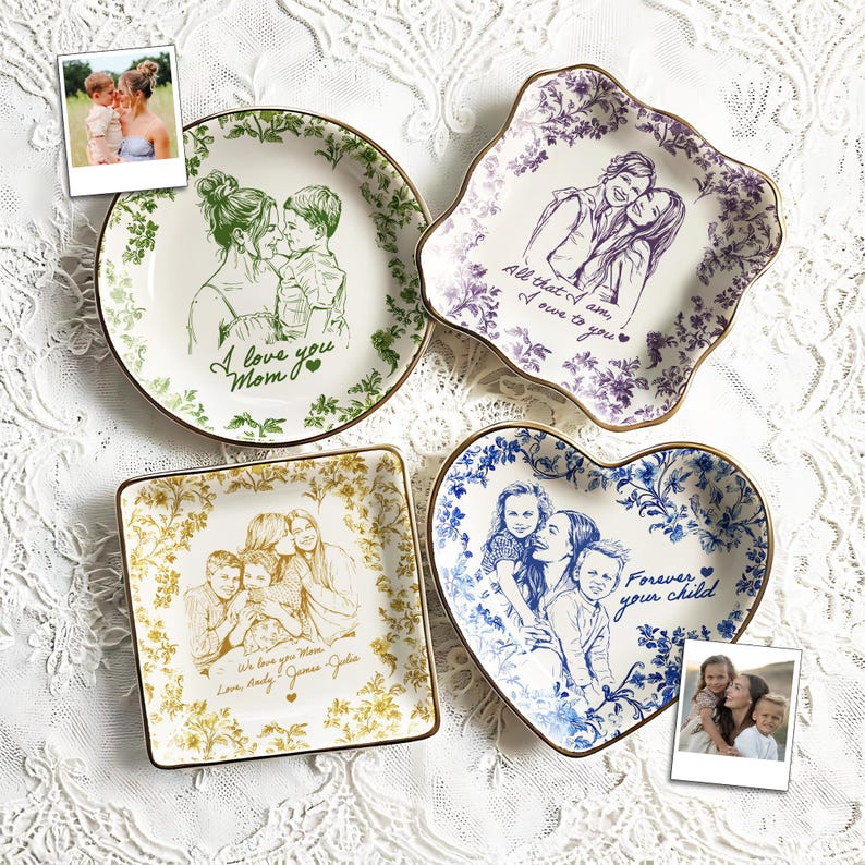 May include: Four decorative ceramic plates with family portraits and floral designs. The plates are in various shapes: round, square, heart-shaped, and a unique wavy design. Each plate has a gold trim and includes text such as "I love you Mom."