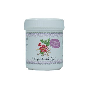 Könnte beinhalten: Ein weißes Glas mit einem rosa und violetten Etikett. Das Etikett zeigt eine Blume und den Text "Kosmetik aus dem Auverwende" und "Teufelsralle Gel".