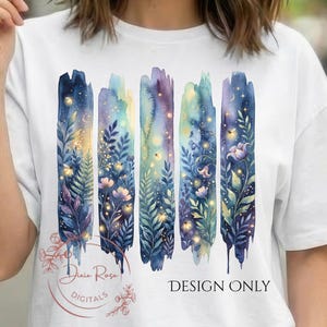 May include: White t-shirt featuring a watercolor design of vertical brushstrokes in shades of blue, purple, and gold, with floral and foliage details. The text "DESIGN ONLY" is printed on the shirt.