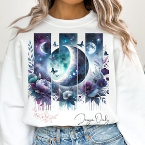 May include: White sweatshirt with a graphic design of a crescent moon, stars, and flowers in shades of purple, blue, and white. The design is framed by vertical lines and has a watercolor effect. The text "Design Only" is printed on the bottom of the sweatshirt.