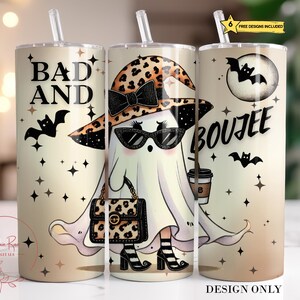 May include: Three 20oz stainless steel tumblers with a Halloween theme. The tumbler on the left has the text "Bad and" with a black bat. The tumbler in the middle has a ghost wearing a leopard print hat and sunglasses, holding a coffee cup and a leopard print purse. The tumbler on the right has the text "Boujee" with a black bat.