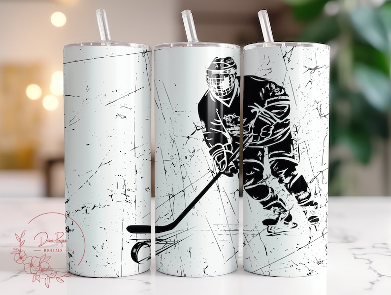 May include: Three white stainless steel tumblers with black hockey player graphics. The tumblers have a distressed white background with black lines.