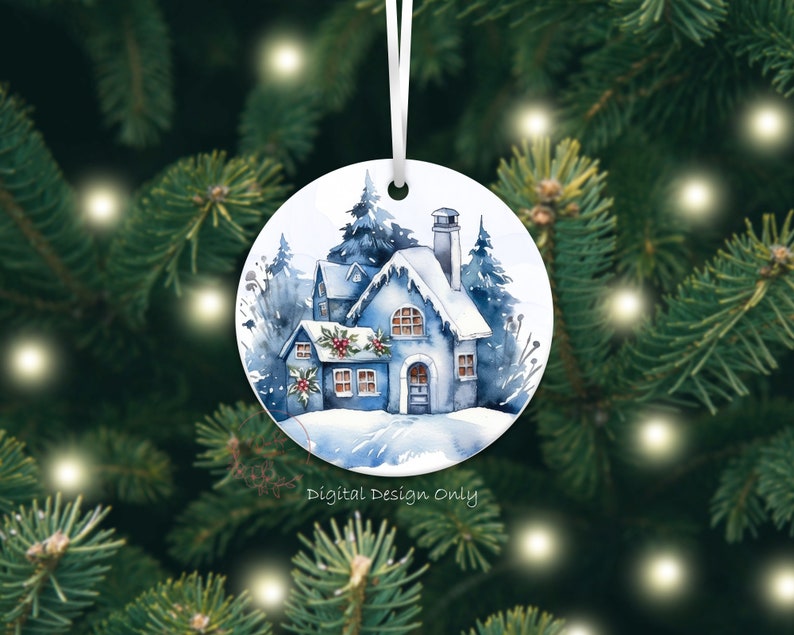K&ouml;nnte beinhalten: Runder Weihnachtsschmuck mit einem Aquarellgem&auml;lde eines schneebedeckten blauen Hauses mit Schornstein und Stechpalmenakzenten. Der Schmuck h&auml;ngt an einem wei&szlig;en Band vor dem Hintergrund eines Weihnachtsbaums. Der Text auf dem Ornament lautet "Digital Design Only."