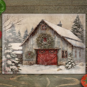 May include: A rustic wooden barn with a red door and a wreath on the front, covered in snow with pine trees in the background.