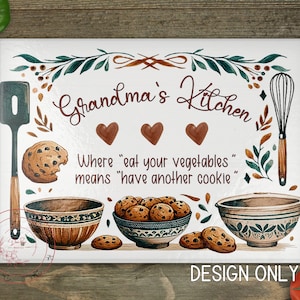 May include: White cutting board with a brown and green design. It says "Grandma's Kitchen" with the text "Where "eat your vegetables" means "have another cookie" underneath. There are illustrations of cookies, bowls, a whisk, and a spatula.