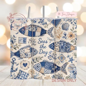 May include: A set of three stainless steel insulated tumblers with lids and straws. The tumblers feature a nautical design with blue patchwork fish, seashells, and floral accents on a cream background. The text "Seas the Day" is also displayed.