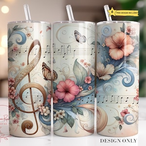 May include: Three insulated tumblers with floral and musical designs. Each tumbler features a different design, including a treble clef, butterflies, and musical notes. The tumblers are adorned with pink and white flowers, and blue and beige accents. The text "DESIGN ONLY" is visible.