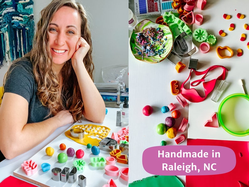 May include: A woman sits at a table with colorful polymer clay and tools for making jewelry. The table is covered with a white tablecloth. The woman is smiling and looking at the camera. The text "Handmade in Raleigh, NC" is visible in the image.