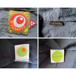 May include: A dark blue jacket with a green and orange logo that says "pygmees" and a smaller logo with a red circle and the text "pygmees". The jacket has a label that says "100% polyester" and another label that says "www.pygmees-parlimlp.com made in Indonesia".
