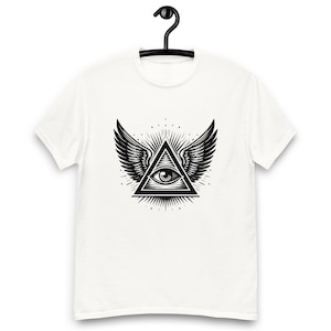 May include: White t-shirt with a black and white graphic of an eye inside a triangle with wings. The eye is looking directly at the viewer.