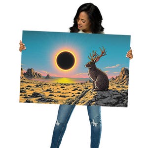 May include: A vibrant art print featuring a desert landscape with a solar eclipse and a jackrabbit with antlers. The artwork showcases a color palette of blue, yellow, orange, and brown, with a detailed illustration style.