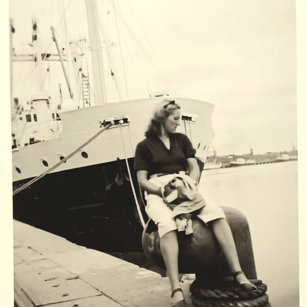 Snap shot - Original Vernacular photograph 1950s - Young woman sitting on a mooring post on a quay.