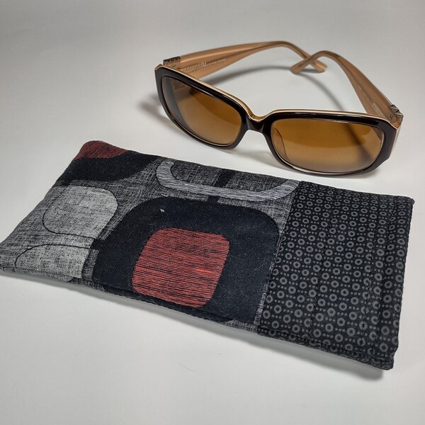 Quilted Padded Sunglass Case.  Soft sided fully lined, 3.5" x 7" to accommodate bigger sunglasses. Black, gray, red color block print fabric