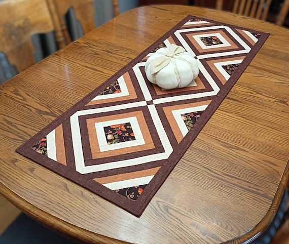 Handcrafted Quilted Table Runner: Rich browns, beige and pumpkin fabrics. Fall floral feature fabric, 17" x 48"