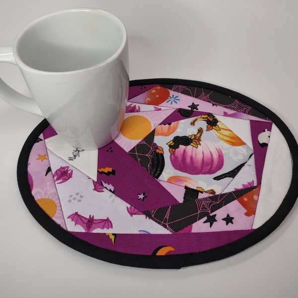 Large, quilted Halloween mug rug. Oval crazy quilt 7.75" x 10" candle pad. Perfect snack mat for a cup and cookies. Fuchsia berry coloring.