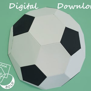 May include: A white and black soccer ball shaped paper craft with fold lines. The text "Fold It Bold" is in the lower left corner. The text "Digital Download" is in the upper right corner. The text "SVG, PNG, PDF" is below the text "Digital Download".
