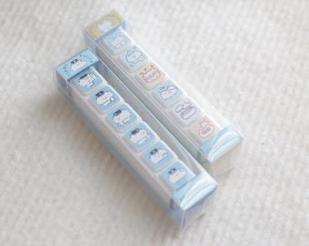 May include: Two clear plastic cases containing six different rubber stamps each. The stamps feature a cartoon raccoon wearing different outfits and accessories. The text "Basic six in one stamp" is at the top of the image and "Raccooncap studio" is at the bottom.